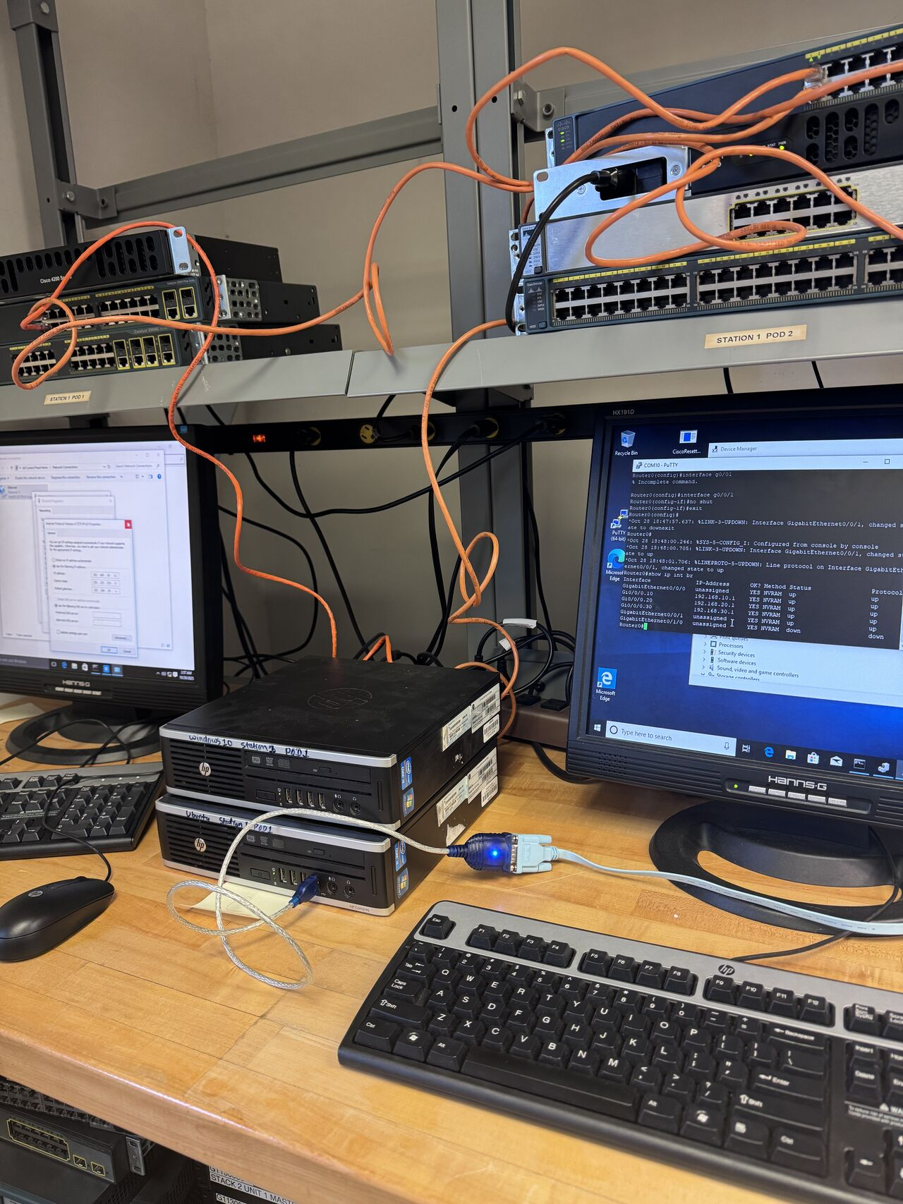 Cisco router and switch rack wired with orange cables, PuTTY console showing router interface configuration