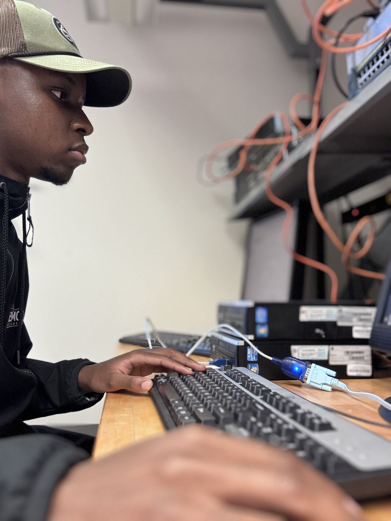 Wilson Katsande working at a console in the university networking lab